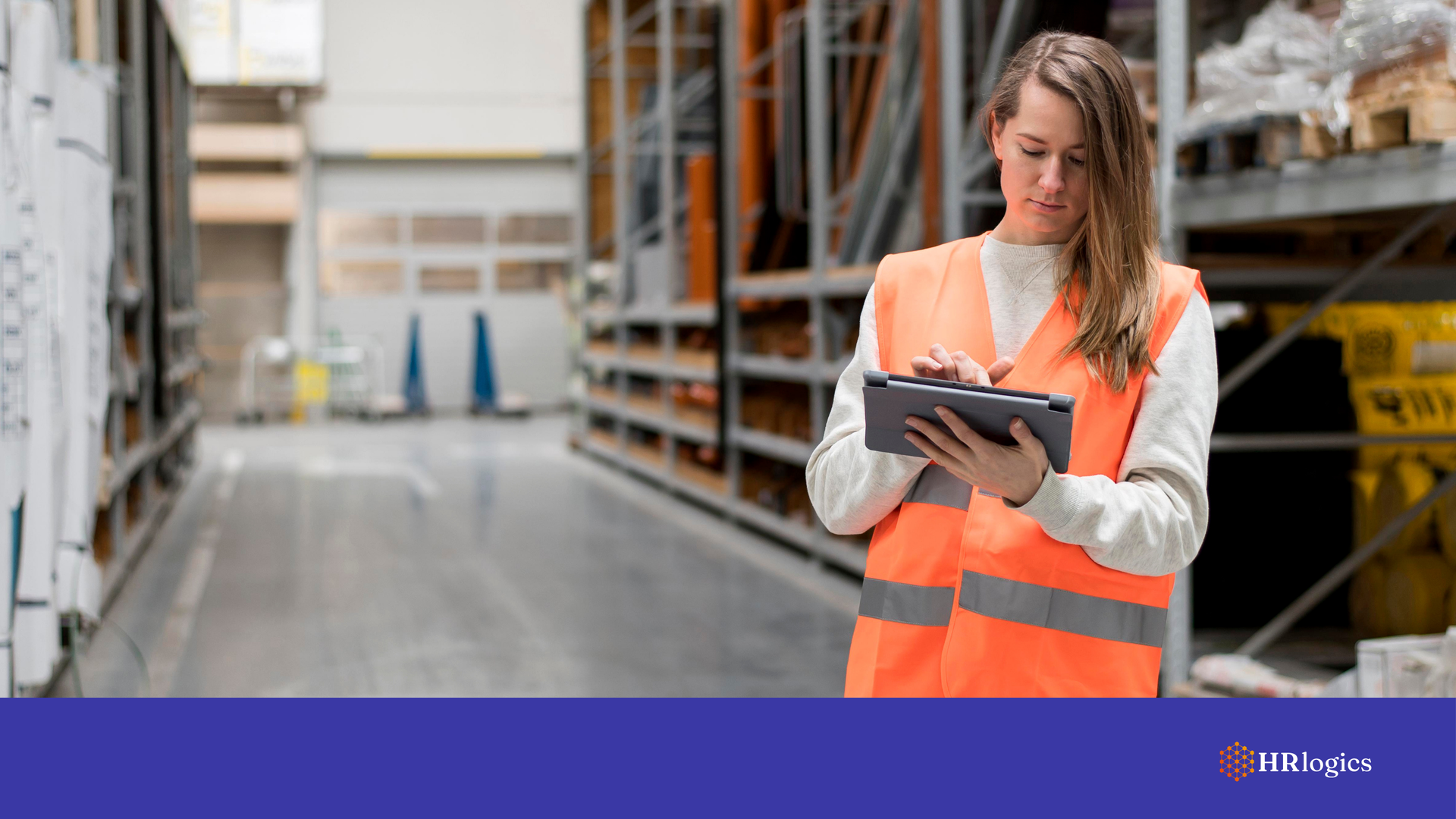 A warehouse manager reviewing hiring documents, ensuring compliance / efficient worforce.